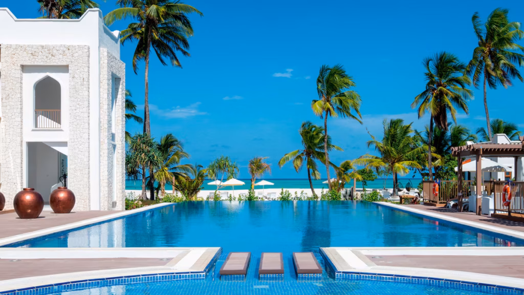 A pool framed by palm trees looking out to the Indian Ocean